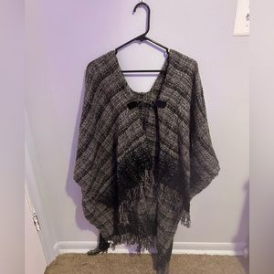 knitted gray/black poncho with brown accents and easy metal clasp